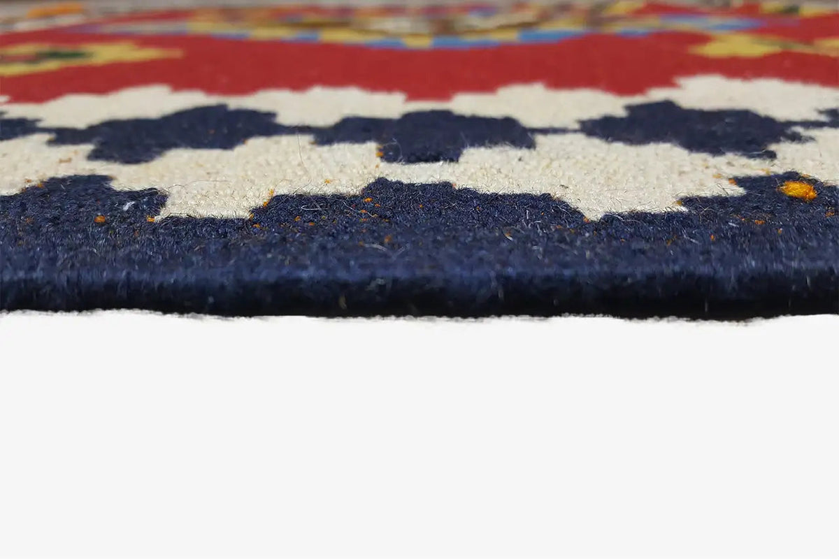 Kilim rug, detail of the rug edge with dark blue pile and colorful patterns