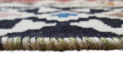 Kilim rug with fringed edges and a dense, multicolored woven pattern