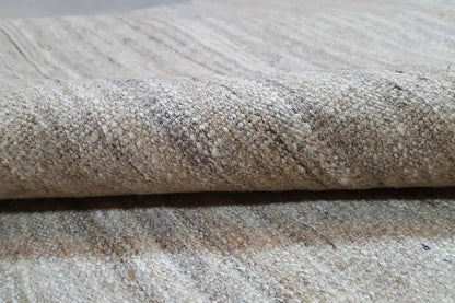 Close-up of the Kelim rug: mottled light beige-gray, dense weave