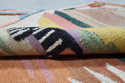 Close-up of a Qashqai kilim rug: colorful woven texture with a multicolored pattern