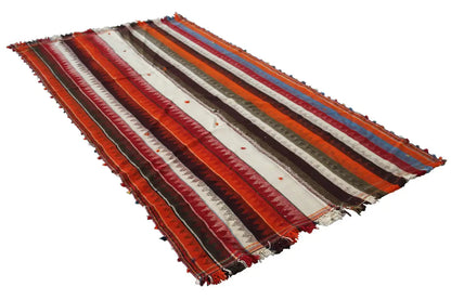 Jajim rug lying flat with a striped pattern and frayed edges