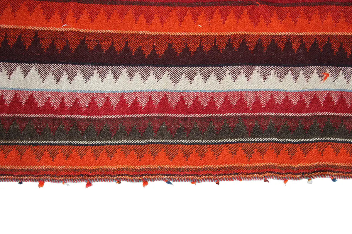 Jajim rug detail: horizontal ornaments and fringed border at the edge