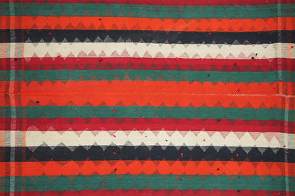 Close-up of a jajim rug: horizontal stripes in red, green, dark blue, and cream.