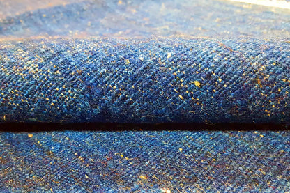 Blue kilim rug with a mottled texture and gold accents