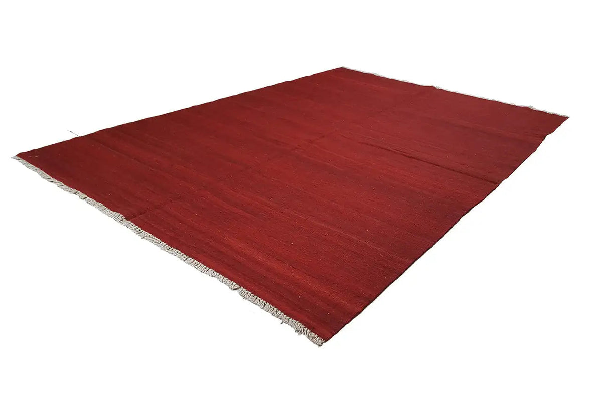 Red kilim rug, simple, low pile, with a slightly frayed woven edge