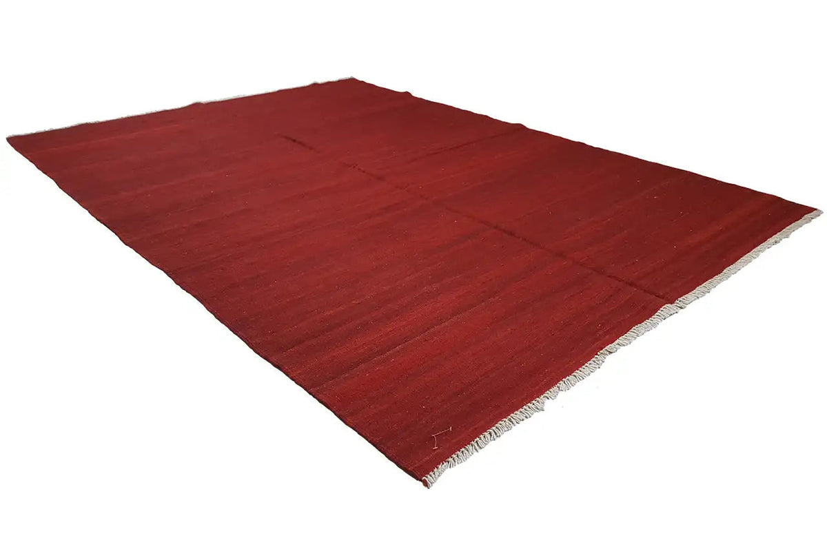 Red kilim rug Simple, corner view, flat weave structure and frayed edge