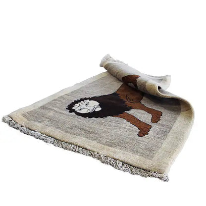Gabbeh rug with lion motif, rolled edge visible; brown lion on beige background