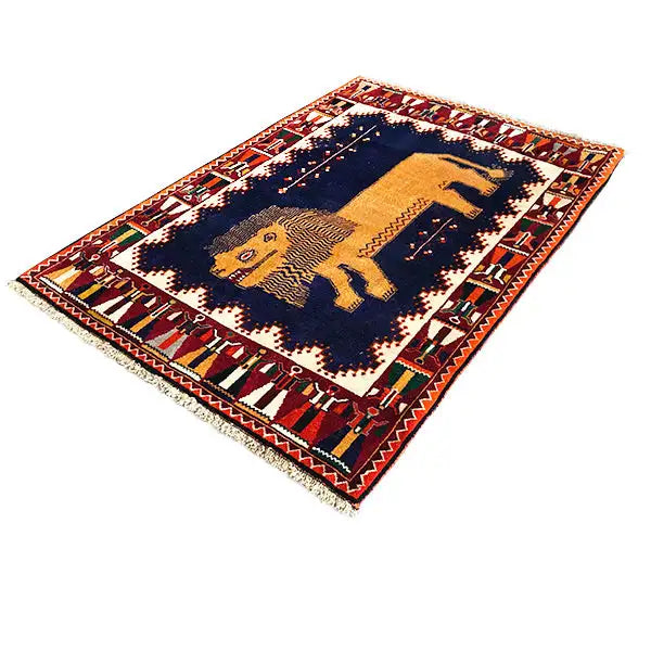 Gabbeh rug with lion motif, dark blue ground, and red border framing