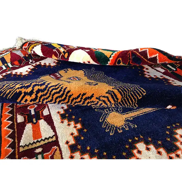Close-up of Gabbeh rug: lion figure and pattern in the dark blue color field