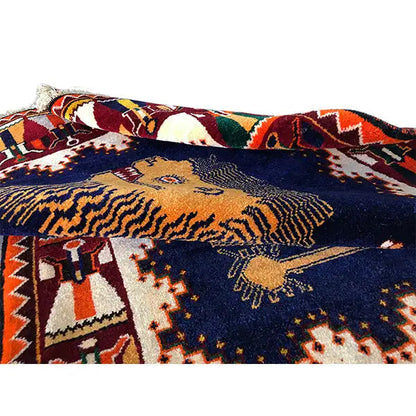 Close-up of Gabbeh rug: lion figure and pattern in the dark blue color field