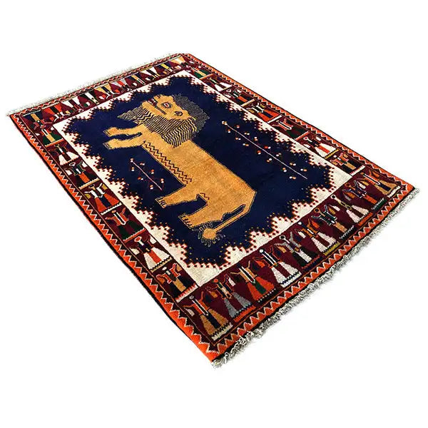 Gabbeh rug with a central lion figure, dark blue background and red decorative borders