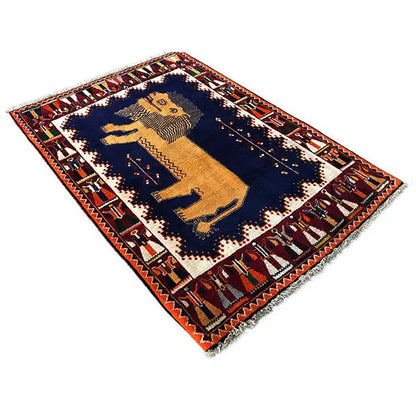 Gabbeh rug with a central lion figure, dark blue background and red decorative borders