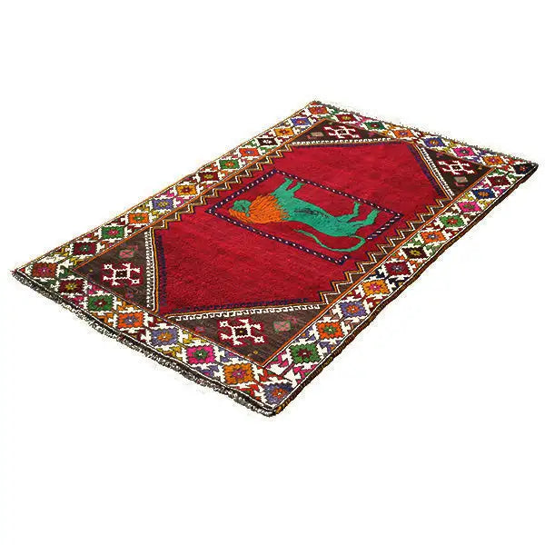 Gabbeh rug lying flat: red field with a green lion motif and colorful ornaments