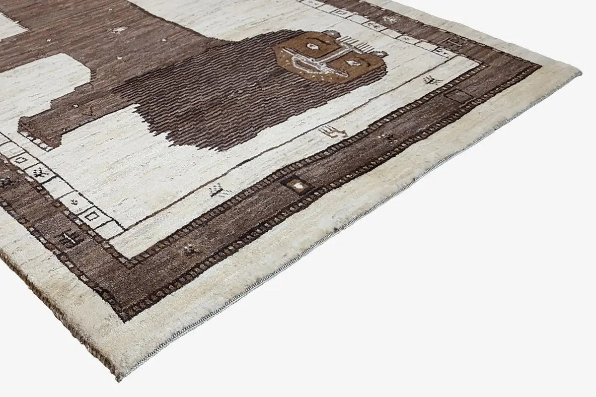 Gabbeh rug, close-up: lion figure and border in brown, beige, and white