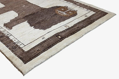 Gabbeh rug, close-up: lion figure and border in brown, beige, and white