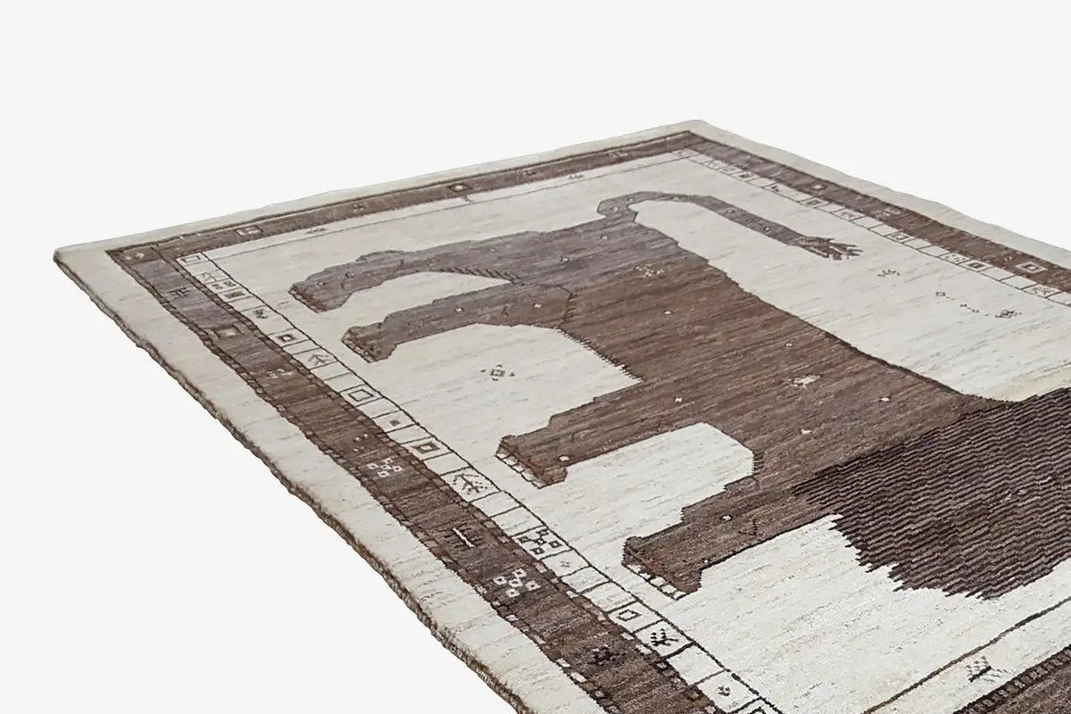 Gabbeh rug with a lion silhouette and surrounding patterned border in brown and light tones
