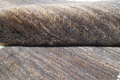 Gabbeh rug with multicolored pile texture, dark border along the edge