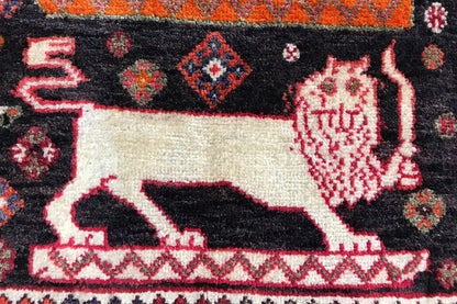 Carpet Poschti Qashqai close-up: white animal motif on a dark background