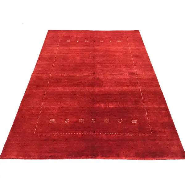 Red Gabbeh rug with a broadly patterned central field and surrounding border
