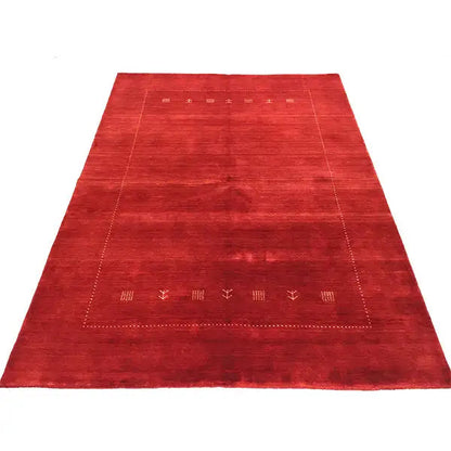 Red Gabbeh rug with a broadly patterned central field and surrounding border