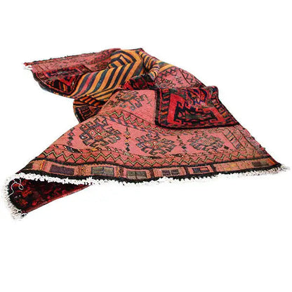 Rolled-up kilim rug, patterned borders in red, beige, and dark contrasting colors