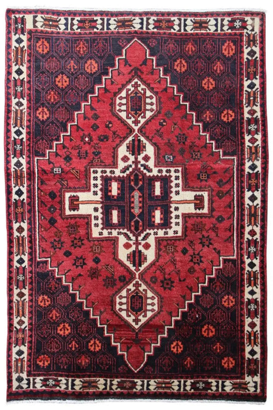 Rug with a red central field, geometric pattern, and white decorative borders
