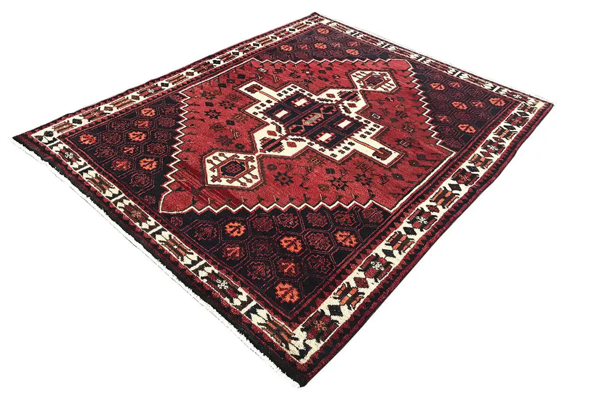 Rug with a square red central motif and a wide ornamental border