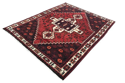 Rug with a square red central motif and a wide ornamental border