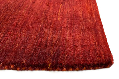 Gabbeh rug, close-up: dense red-brown pile with a short fringed edge