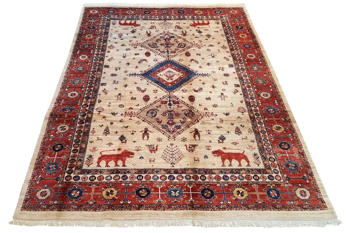 Oriental rug: cream-colored field with a red/blue ornamental border, central medallion, and fringes