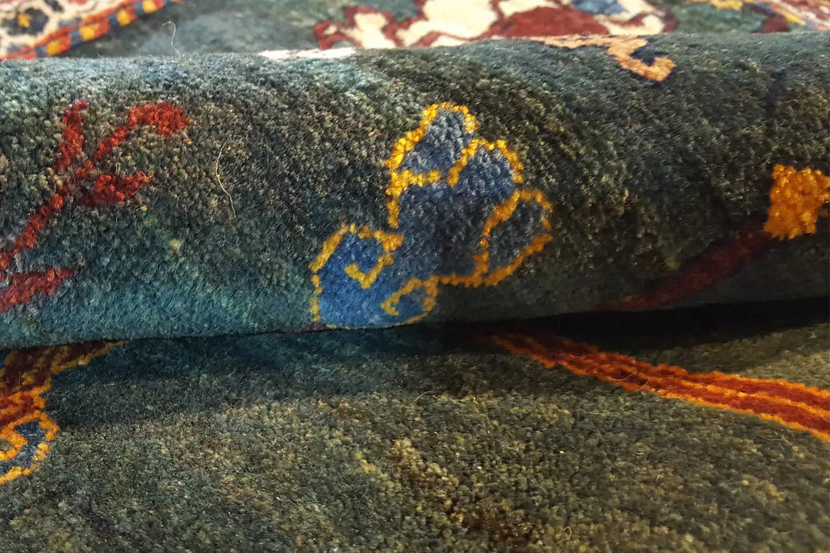 Dense-pile carpet with a blue-and-yellow ornament on a dark background