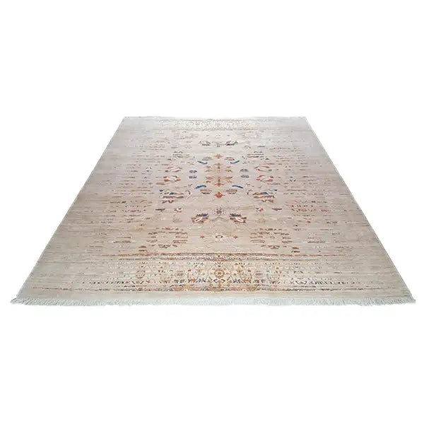Rectangular designer rug with a beige background and centered vintage ornament