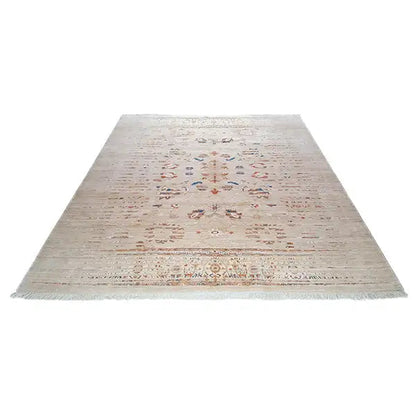 Rectangular designer rug with a beige background and centered vintage ornament
