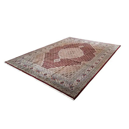 Rug with a central brown and beige medallion and decorative border border