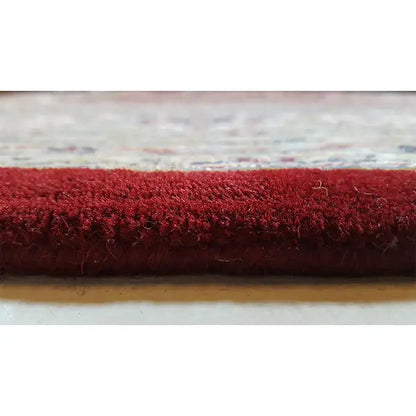 Carpet edge with red pile and a short fringed lower edge
