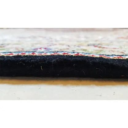 Indo Tabriz carpet edge detail with a dark border and side selvage