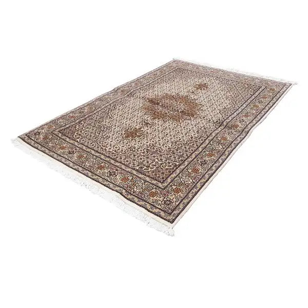 Rectangular Indo Tabriz rug with a beige ground, brown medallion, and border