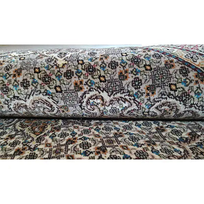 Carpet surface with a small-scale pattern in beige, gray, and colorful accents, smooth