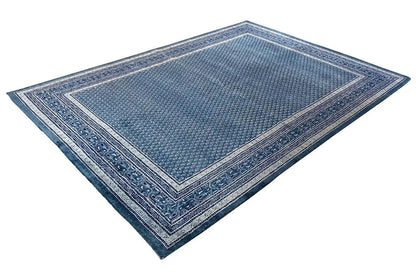 Blue rug with decorative border and delicate ornamental pattern, rectangular