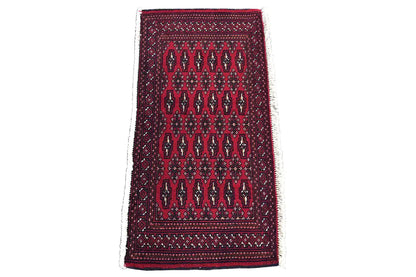 Turkmen carpet 110x51 cm with dark red geometric pattern and border trim