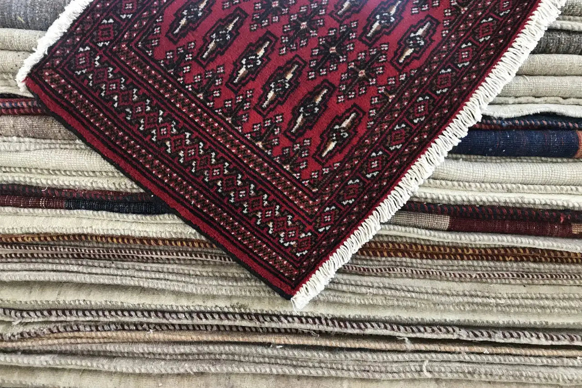 Turkmen carpet 110x51 cm folded, dark red with borders and light-colored fringes
