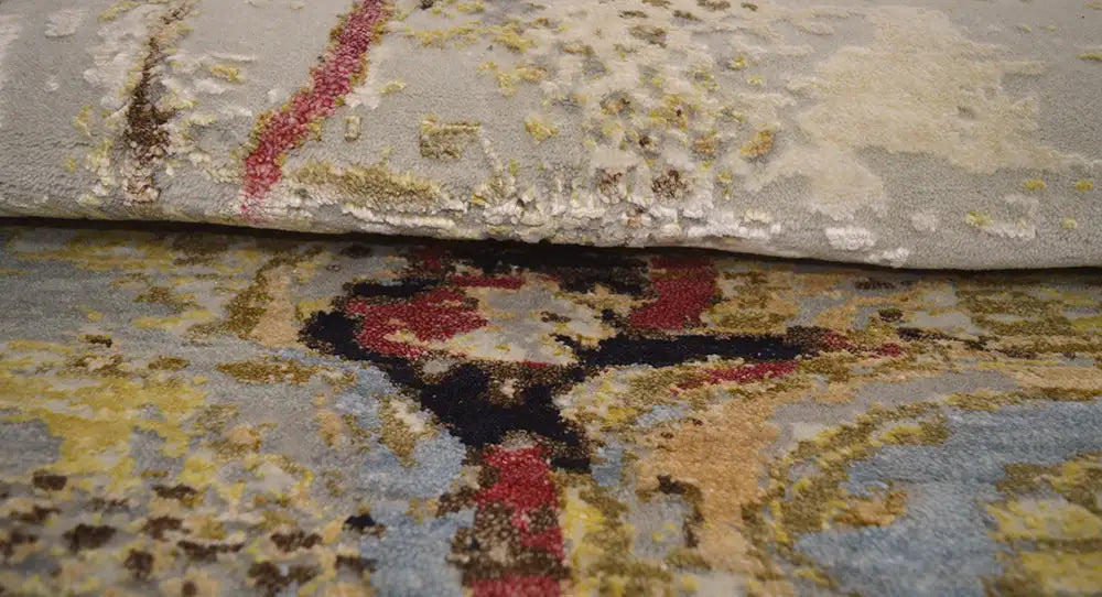 Round modern rug with a yellow-gray pattern and a visible pile edge.