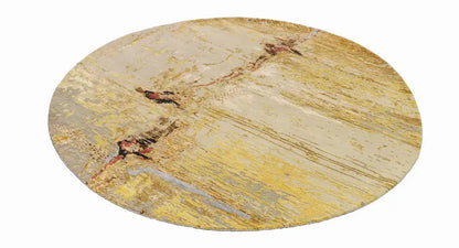 Round modern rug with a beige, yellowish, and brownish abstract pattern.