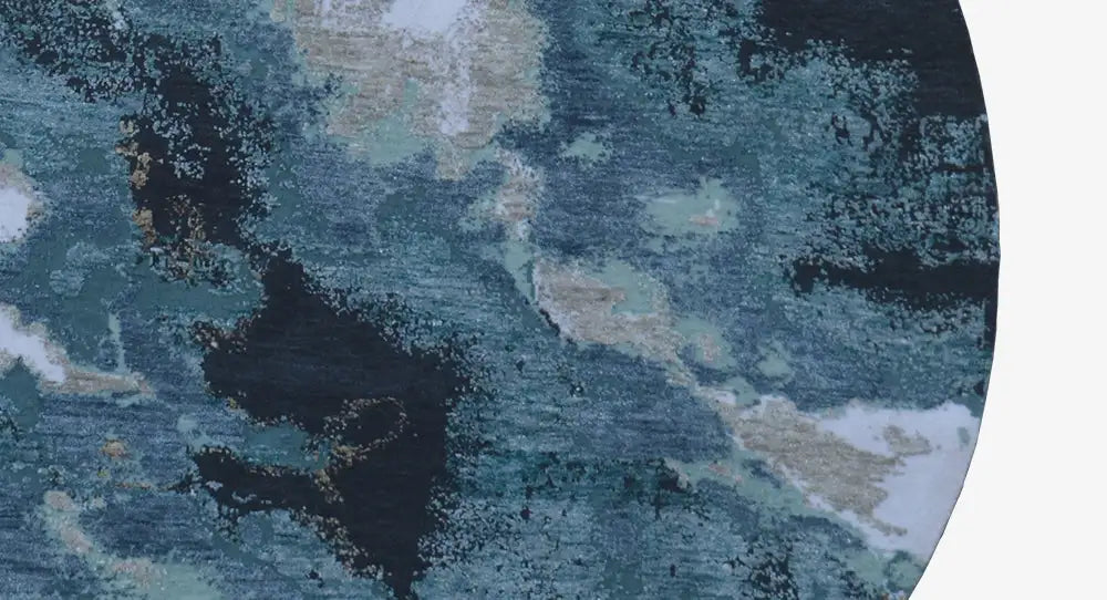 Close-up of the round designer rug: abstract blue-and-beige pattern, textured.