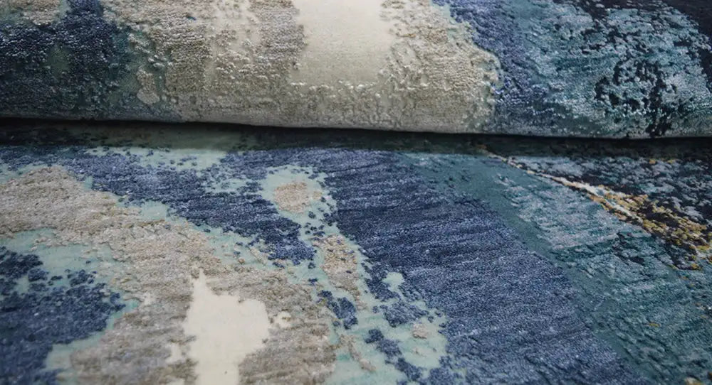 Close-up of the round designer rug with abstract blue and beige spots.