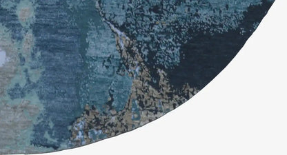Close-up of the carpet edge: round, abstract blue-beige pattern with a dense texture.