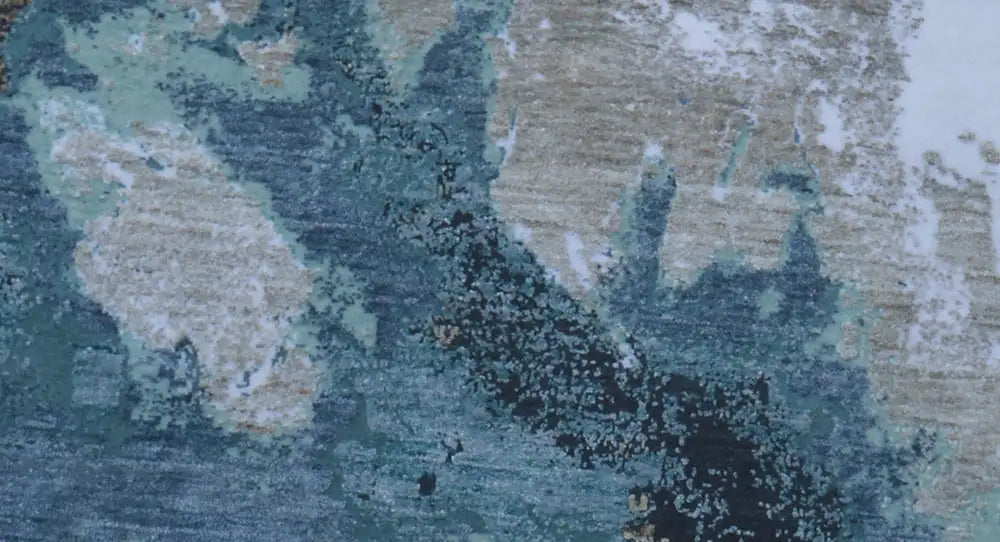Carpet detail with abstract blue and beige color fields, with a slightly mottled appearance.