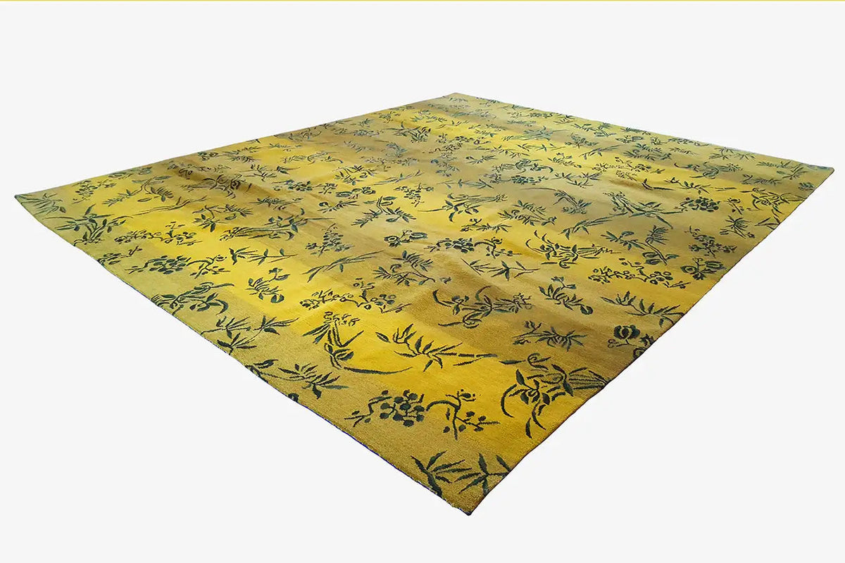 Designer rug, yellow with a dark floral pattern and triangular view