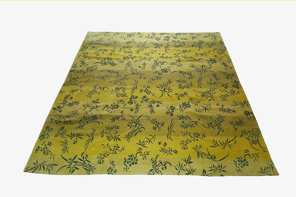 Designer rug, yellow, with a delicate leaf and vine pattern and a visible border edge