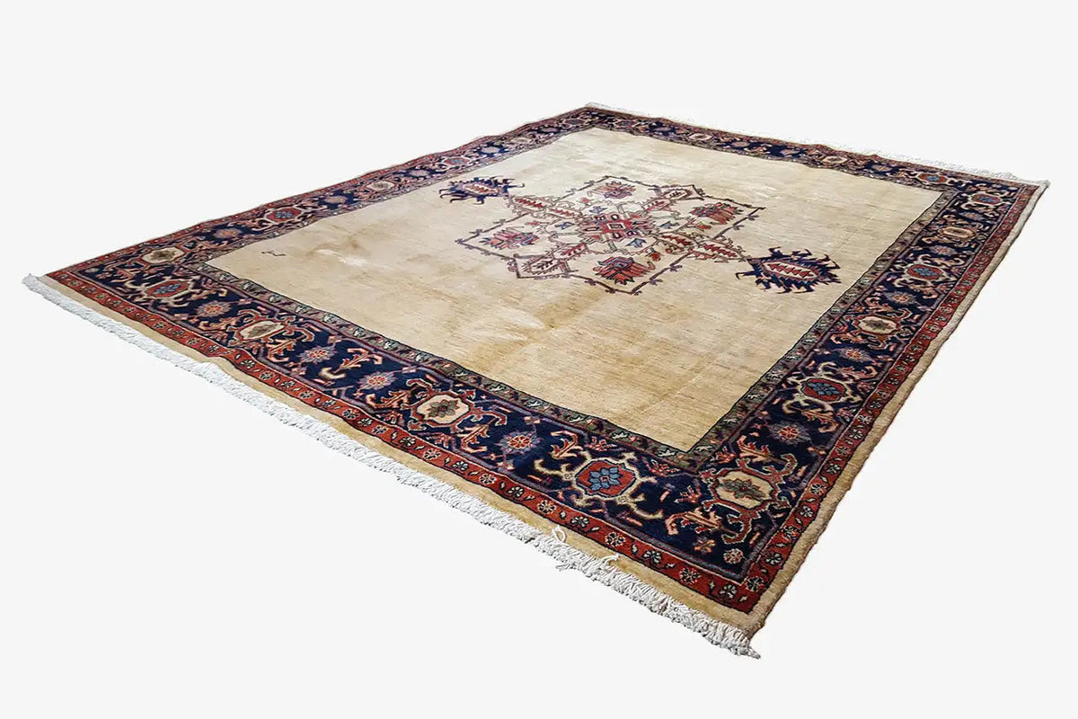 Heriz rug, cream field with a central medallion, framed in blue and red